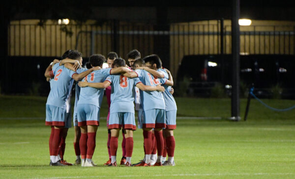 women athletes in a huddle